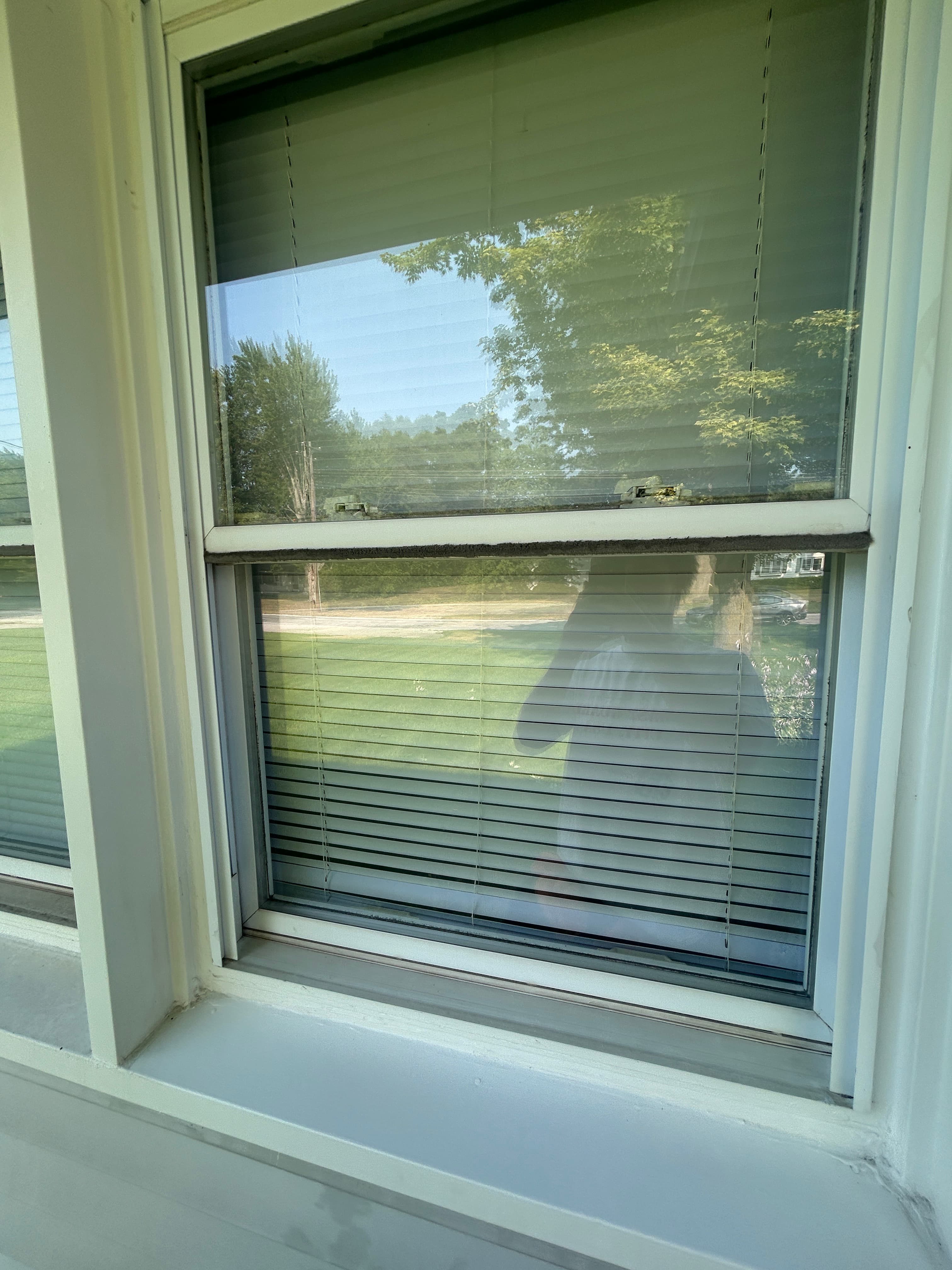 Window track with visible dirt and grime buildup before cleaning